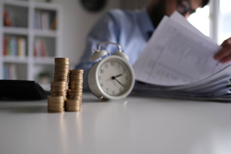 Coins next to a clock - Wage Disputes